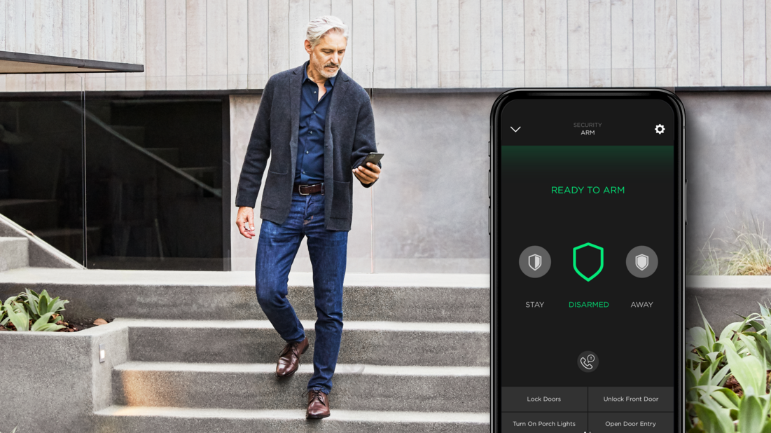 A man leaving his luxury home with an insert on the right of the security user interface of the Savant app.