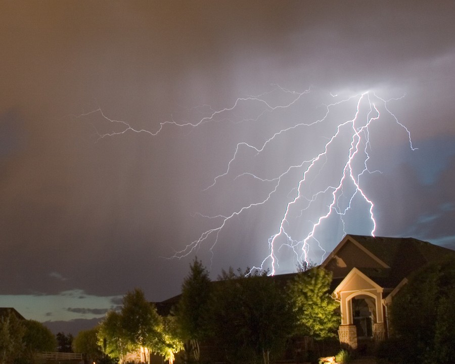 A lightning strike over a house.